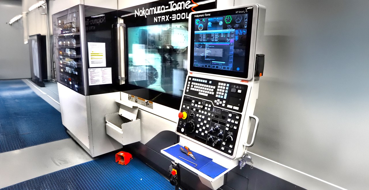 Advanced CNC machine with control panel and monitor displayed prominently.