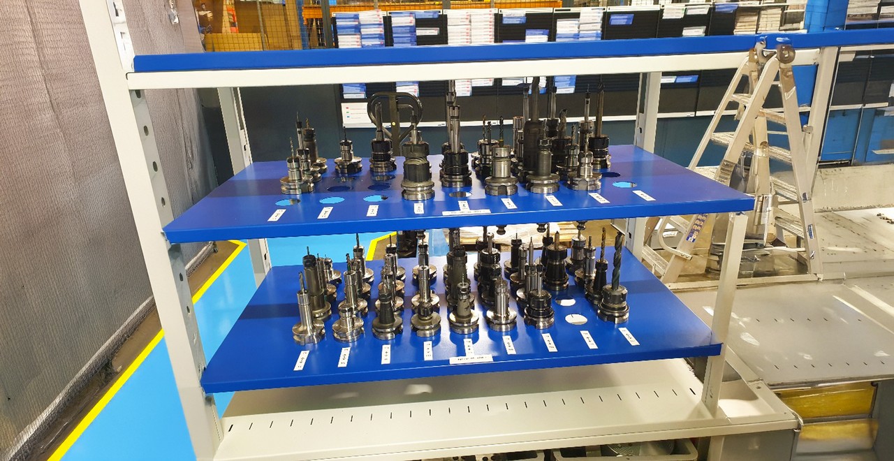 Organised display of various tools and components on shelves.